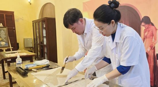 Staff of the Scientific Research Division restoring and conserving historical documents at Tang Tho Pavilion